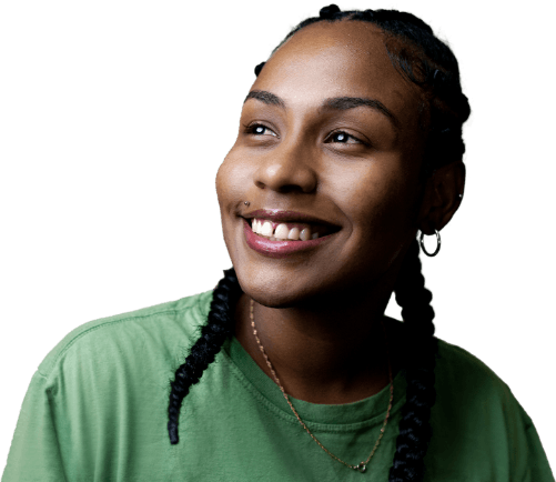 A young woman with braided hair, wearing a green shirt and small hoop earrings, smiles and looks upward against a plain white background.